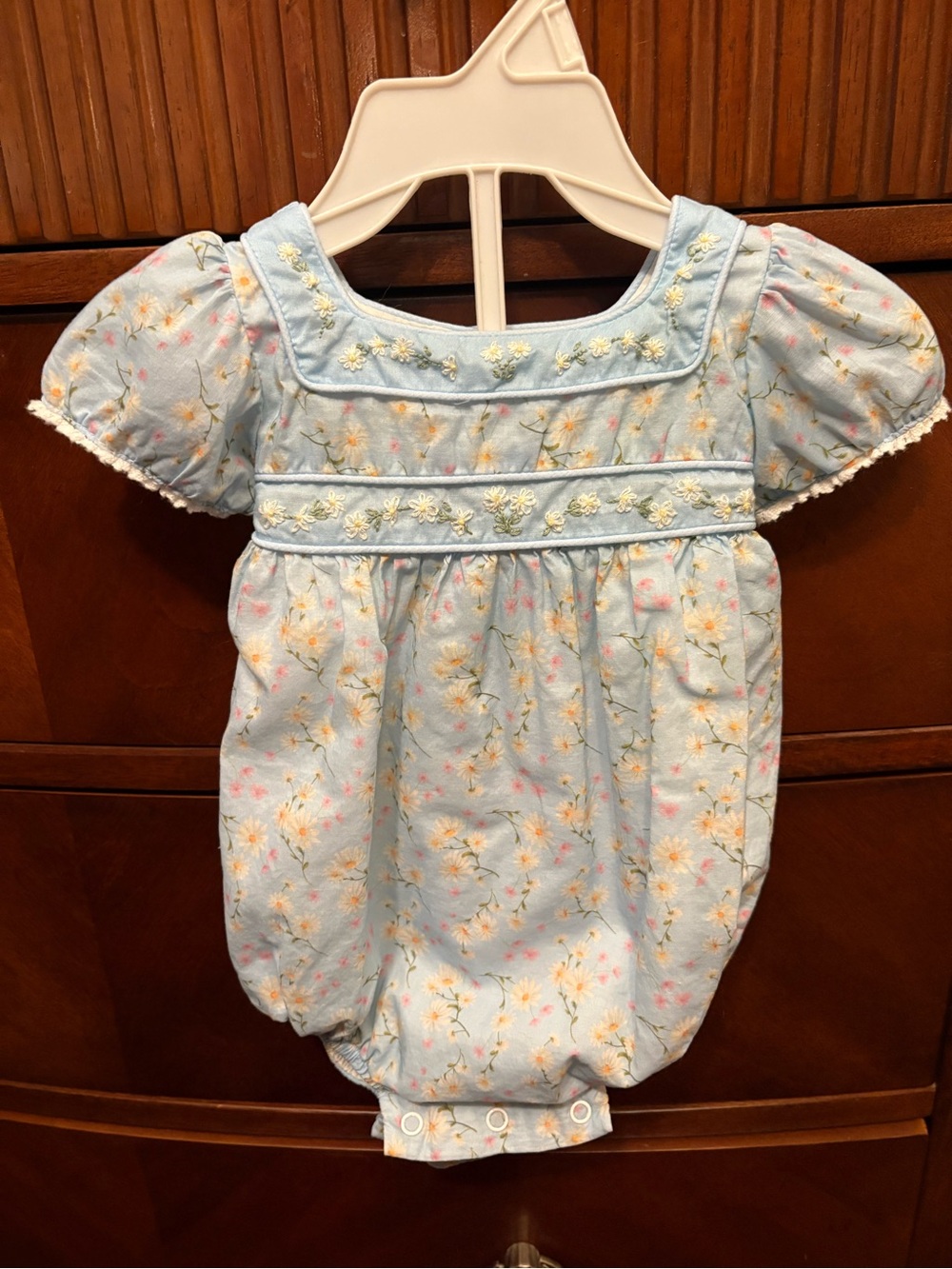 Dondolo Smocked Floral Baby Bubble Romper in Light Blue. Size 6m